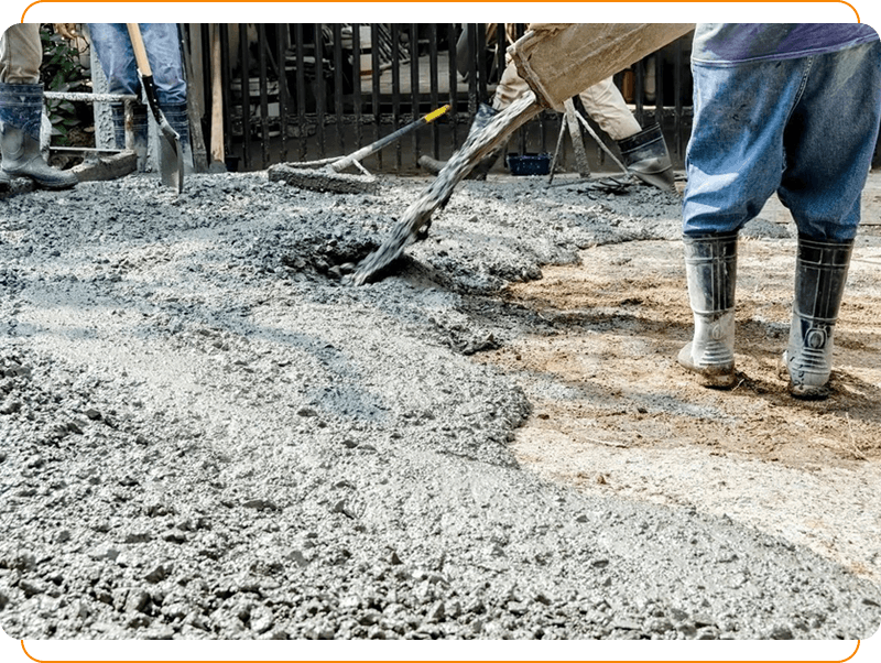 A person is using a shovel to spread cement.